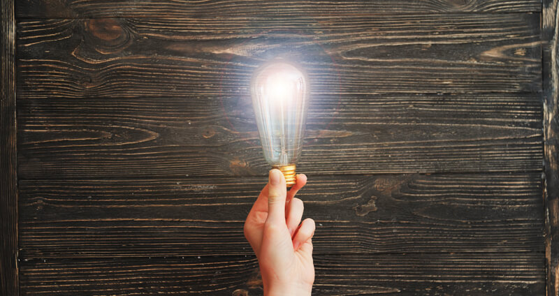 A hand holding a lightbulb to represent Horizon Controls Group Core Values - Energy